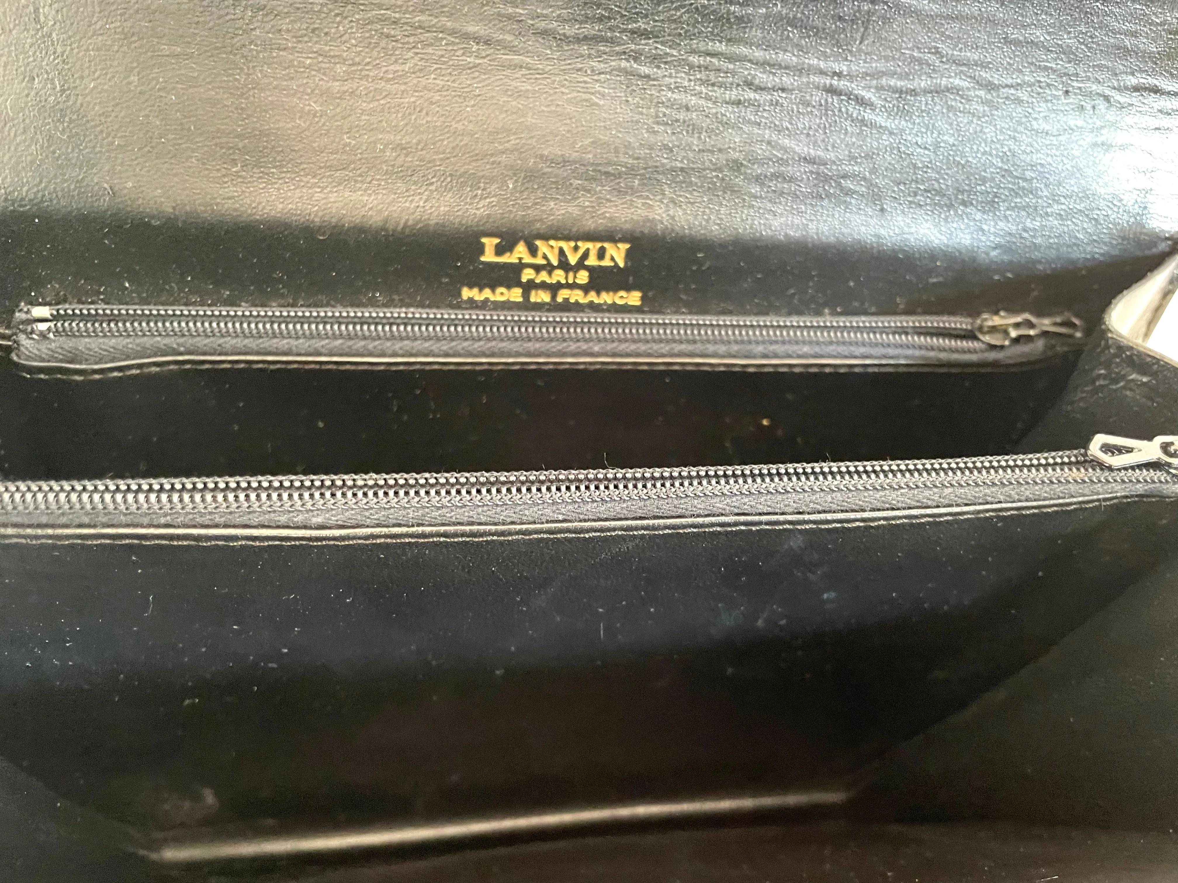 Vintage Lanvin black leather shoulder bag with iconic golden logo motif, Classic purse for daily use. 050222ya1