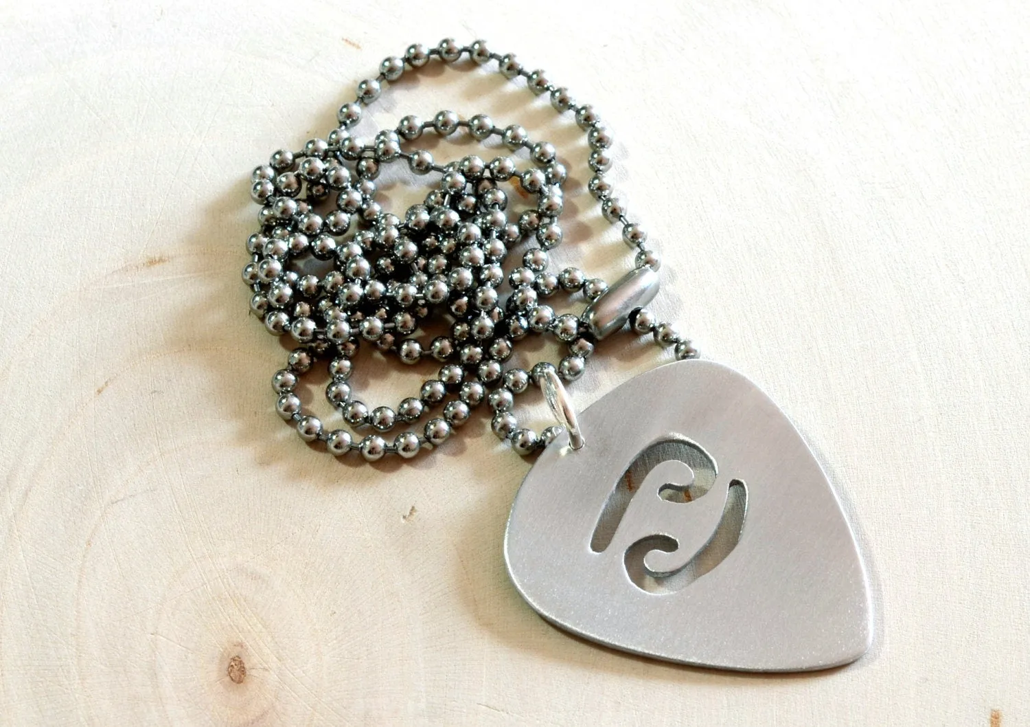 Zodiac sign guitar pick necklace with personalized astrology theme in various metals