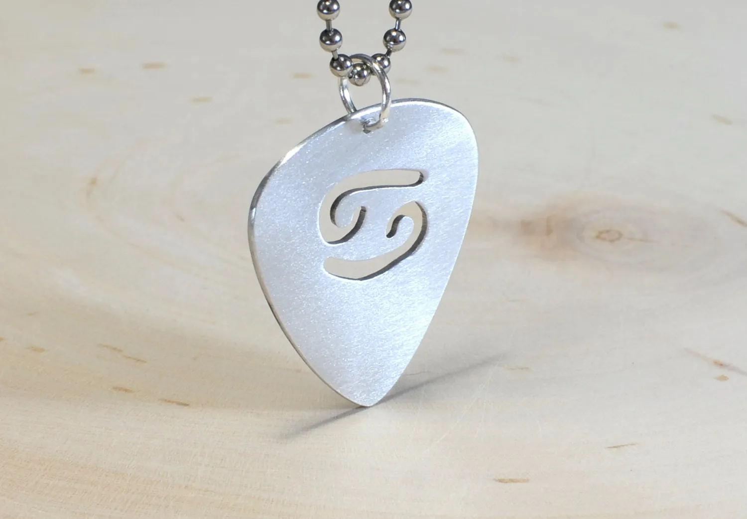 Zodiac sign guitar pick necklace with personalized astrology theme in various metals